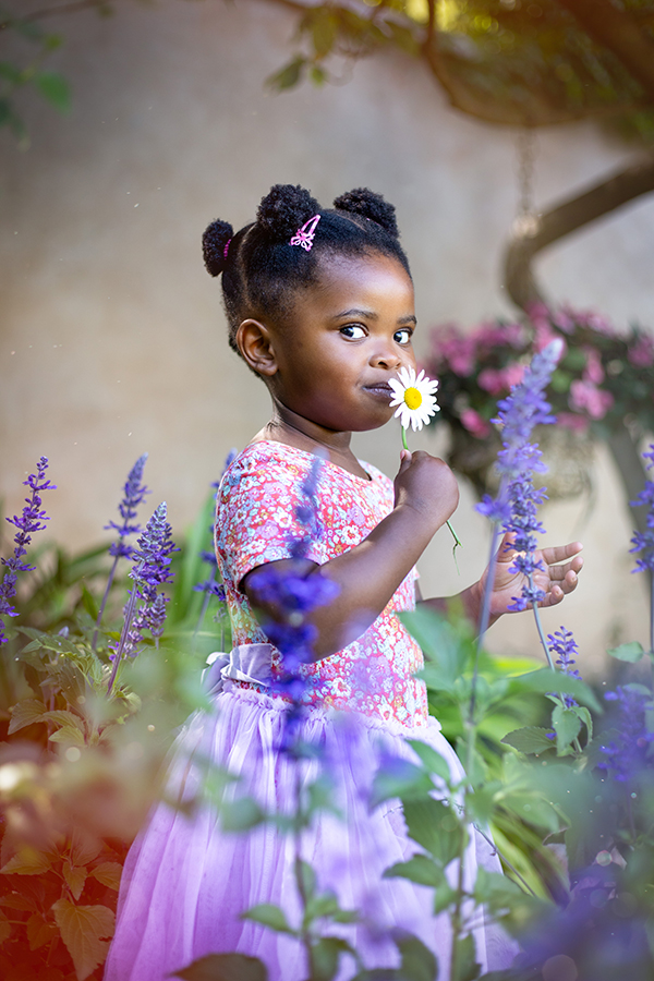 girl smelling flower